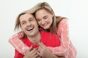 73609024 - cheerful young couple at home. woman and man hugs and kisses.