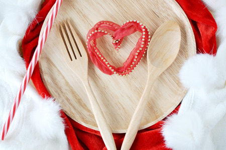 48357232 - heart shape on wooden dish with fork and spoon